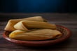 Corn tamales on a Mexican clay plate