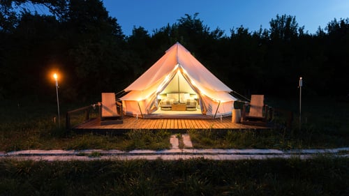 Tent glamping at dusk in forest