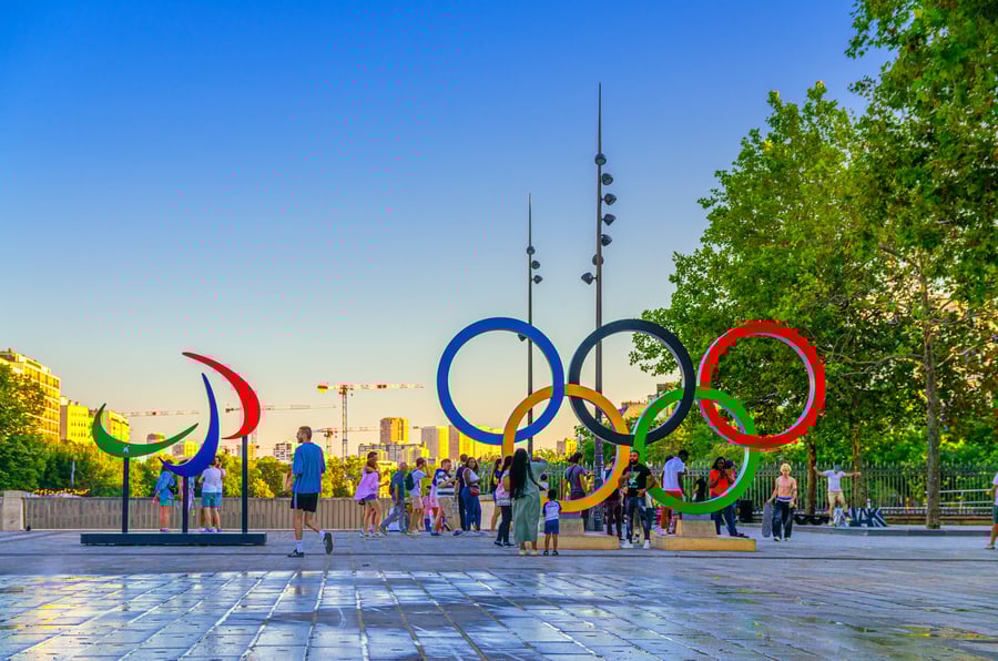 Tourists posing near Olympic Rings installation during Olympic Games Paris 2024