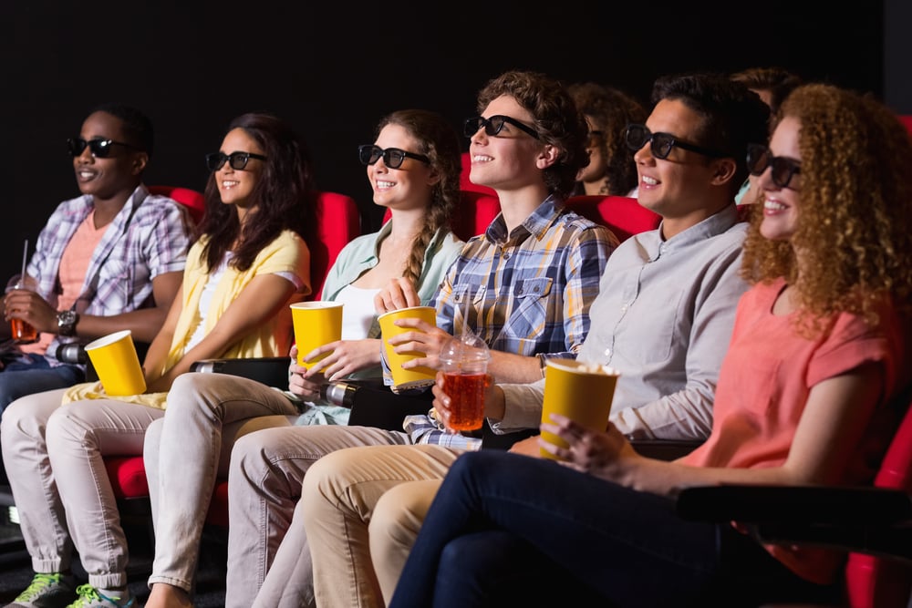 Young friends watching a 3d film at the cinema