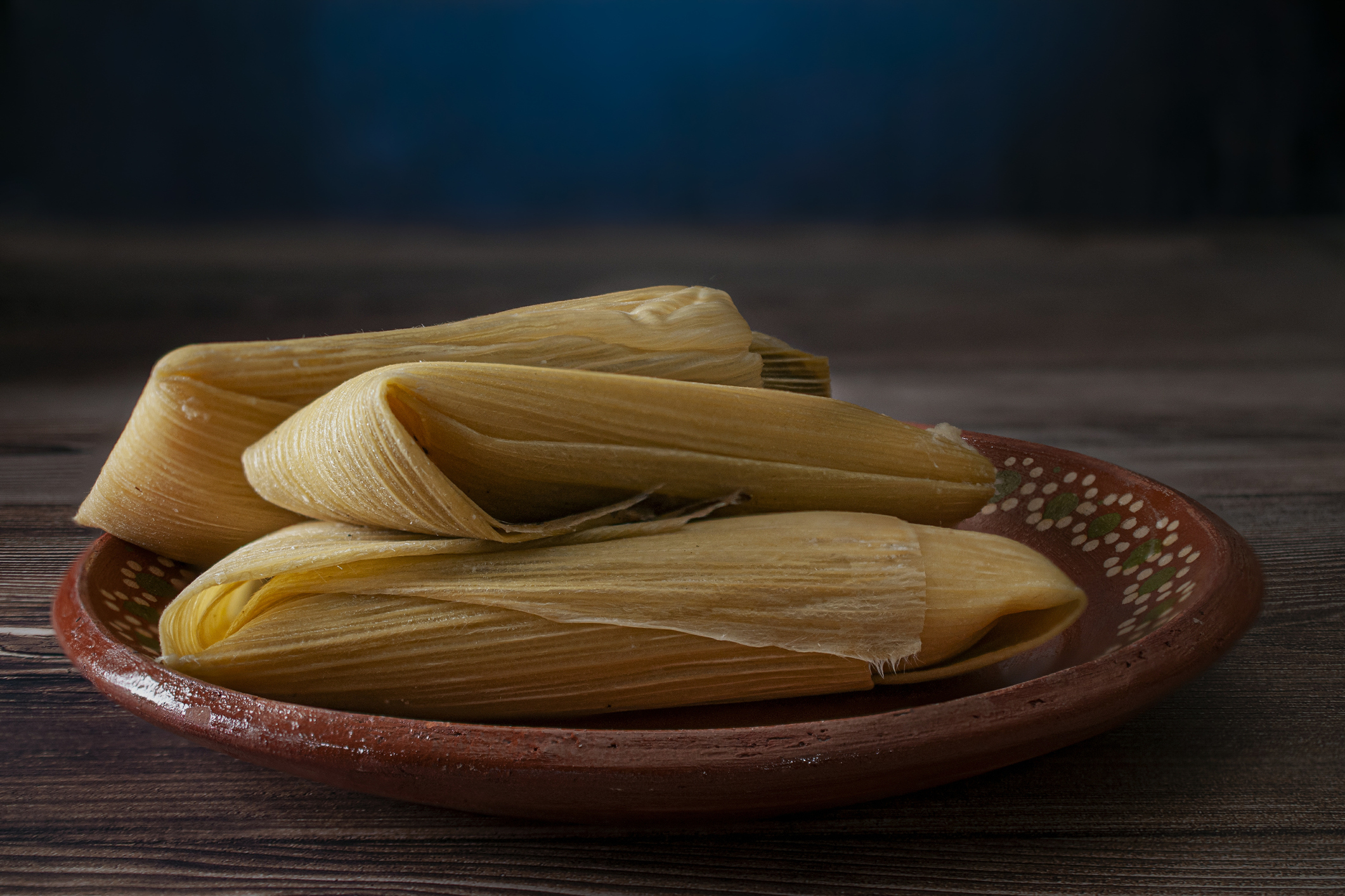 Corn tamales on a Mexican clay plate